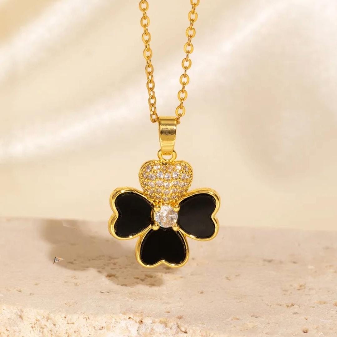 Collar con colgante de trébol de cuatro hojas, en plateado y dorado.